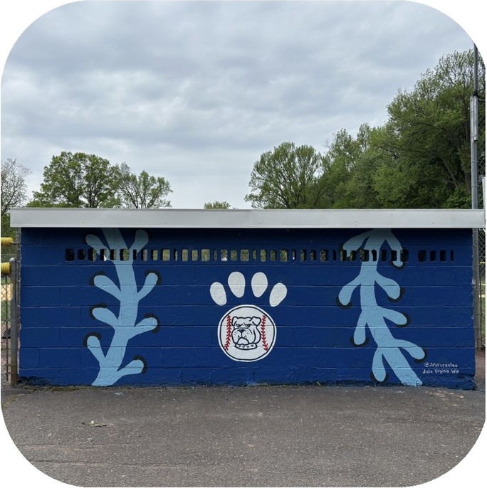Dugout mural of giant light-blue baseball stitching curving around a bulldog paw print and baseball